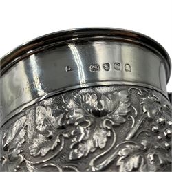 George III silver mug with leaf capped handle, later chased decoration and on a pedestal foot H10cm London 1818