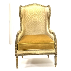 19th century giltwood wing back armchair with leaf and bead carved decoration on fluted turned supports
