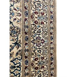 Silk inlaid Persian Kashan ivory ground rug, central floral design star medallion surrounded by trailing leafy branches and stylised plant motifs, guarded border with repeating pattern decorated with scrolls and floral motifs