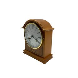 Two 20th century mantle clocks. A light maple wooden cased 8-day mantle clock and a quartz carriage clock in a brass effect case. Mantle clock with a twin train German Hermle floating balance movement striking the hours and half hours on twin bells, dial inscribed  “Fox & Simpson”. Timepiece carriage clock with a dial inscribed “Rapport, London” 