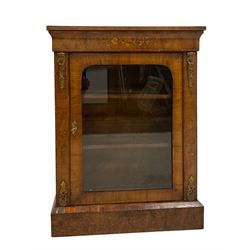 Late 19th century walnut pier cabinet, rectangular top over cavetto frieze inlaid with floral marquetry decoration, the door glazed with arched rectangular panel, enclosing two shelves, uprights topped with foliate gilt metal mounts above scrolling flower head inlay, raised on plinth base