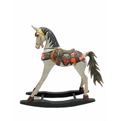 Late 20th century carved wood child's rocking horse, with polychrome painted saddle and stirrups, L105cm