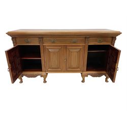 Early 20th century walnut sideboard, rectangular top over reeded frieze, fitted with three drawers and four panelled cupboards, fluted uprights with foliate capitals, apron carved with central shell and extending acanthus carving, raised on cabriole supports with pad feed 