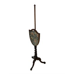 19th century mahogany pole screen, shield shaped needlework adjustable banner, spiral turned support above splayed cabriole feet with scroll carving