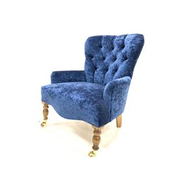 Quality Victorian style upholstered button back armchair, raised on turned beech front supports with brass cup castors W66cm