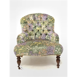 Victorian style upholstered bedroom chair, covered in deep buttoned floral fabric, raised on turned supports 