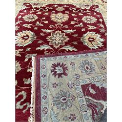 Knotted wool red ground rug with floral design 314cm x 243cm