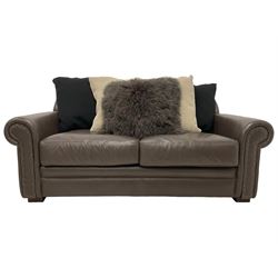 Tetrad - two seat sofa upholstered in brown leather with contrasting scatter cushions 