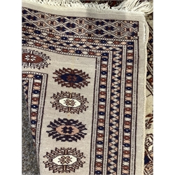 Afghan Bokhara style beige ground rug, with gul motif enclosed by triple guarded border, (141cm x 80cm) and a silk on cotton cream ground rug, (104cm x 63cm)