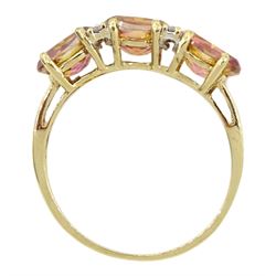 9ct gold three stone azotic topaz ring, with four diamond accents set between, hallmarked 