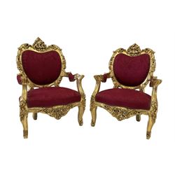 Pair French style gilt armchairs, the frame decorated with scroll work and foliage, upholstered in red fabric