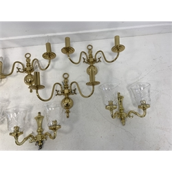 Set of three modern brass two branch wall lights with glass shades, height of backplate 20cm, and a set of four brass two branch wall lights