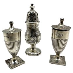 Pair of late Victorian silver pepperettes of urn form London 1896, together with a larger Victorian engraved silver example 4.7oz 