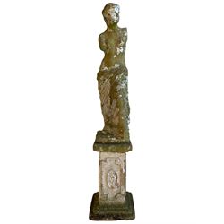 20th century cast stone two-piece garden figure in the form of Venus de Milo or Aphrodite of Melos, on a square plinth the stepped base, decorated with oval floral panels within Greek key borders 