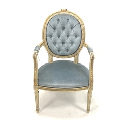 Louis XV style cream and gilt painted open armchair, the buttoned back rest over scrolled arm terminals and seat, raised on turned fluted supports, upholstered in blue velvet