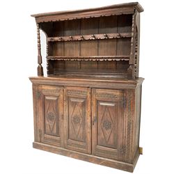 DD CHS - Antique welsh oak dresser, the carved raised back fitted with two shelves and eight turned hooks over base with cushion frieze and lozenge carved panel dated 1641, flanked by two matching panelled doors enclosing plain interior, on a skirted base W163cm