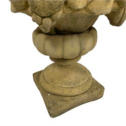 Pair of composite stone garden ornaments in the form of urns filled with fruit