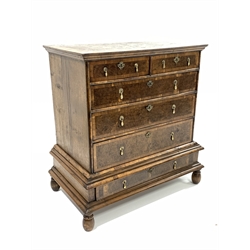 Early 18th century and later Queen Anne burr walnut and oak crossbanded chest on stand, the top section fitted with two short and three long graduated drawers, one long drawer under, raised on turned supports
