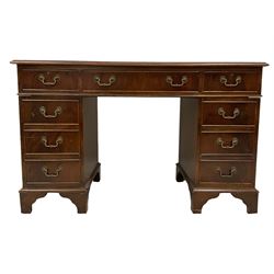 Edwardian mahogany twin pedestal desk, rectangular top with inset leather writing surface and moulded edge, fitted with nine cockbeaded drawers, raised on bracket feet