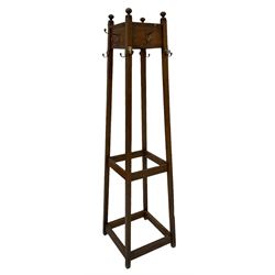 20th century oak hat and coat stand, fitted with brass hooks and raised on square supports, united with stretchers 