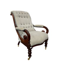 20th century armchair with mahogany frame, upholstered in blue fabric, raised on turned supports, terminating in brass castors 