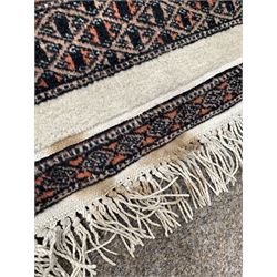 Persian design Bokhara ground rug with repeating gul and lozenge design 195cm x 125cm