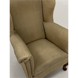  Georgian design wing back armchair, upholstered in cream fabric, raised on walnut cabriole front supports, W79cm  