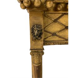 Regency gilt pier glass mirror, the projecting cornice with spherical mounts over applied lattice work with poppy heads, flanked by lion mask mounts, the rectangular plate between cluster column pilasters with composite capitals