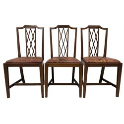 Regency design mahogany twin pillar dining table, oval top with brass inlaid stringing and reeded edge, on sabre tripod bases with brass paw feet and castors, with additional leaf (W129cm D105cm H78cm); set of six edwardian mahogany chairs, high back with lattice splat and satinwood stringing, tan leather drop-in seats (W47cm H97cm)