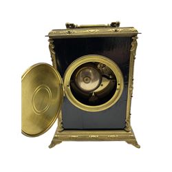 A French mantle clock c1900 in an ebonised case with brass mounts and carrying handle, enamel dial with Arabic numerals, minute markers and brass fleur di Lis hands, eight-day striking movement striking the hours on a bell. With an integral pendulum.



