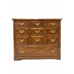 18th century style oak chest of drawers , fitted with nine small and one long drawer, raised on bracket supports with recessed castors W89cm, H76cm, D68c