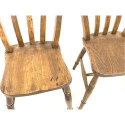 Set of four country elm and beech dining chairs, with shaped seats raised on ring turned supports and stretchers