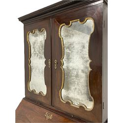 George III Chippendale design mahogany bureau bookcase, the projecting cornice decorated with applied blind fretwork, the two panelled doors with inset shaped mirror plates and gilt metal slips concealing two adjustable shelves, over pigeonholes and correspondence drawers, two sliding candle trays below, the fall-front enclosing fitted interior with shaped baize inset, the central cupboard decorated with blind fretwork of interlocking circles, flanked by pigeonholes and drawers, over three graduating cock-beaded drawers, each with pressed brass pierced escutcheons and handle plates, lower moulded edge over shaped ogee feet

Provenance - property of a nobleman 