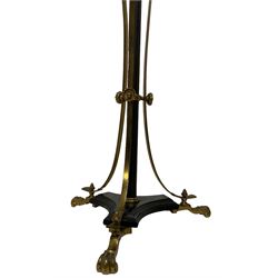 Victorian brass and ebonised metal standard lamp, the triform tier decorated with gilt festoons and downswept uprights, raised on scrolled feet