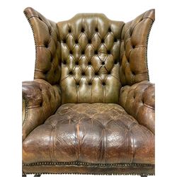20th century Georgian design wingback club armchair, hardwood-framed and upholstered in deeply buttoned brown leather with stud work, on square supports united by H-stretchers 