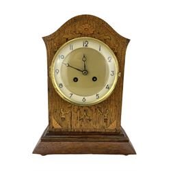 Two early 20th century wooden cased 8-day mantel clocks -  one with an oak case, twin barrel striking movement striking the hours on a bell, the other in a mahogany case with a timepiece movement and cylinder platform escapement, both dials with arabic numerals.