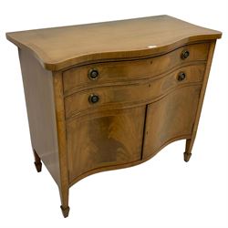 20th century mahogany serpentine side cabinet, crossbanded top over two drawers and double cupboard, fitted with circular pressed and pierced handle plates and laurel leaf wreath handles, figured drawer and door fronts, on square tapering spade feet