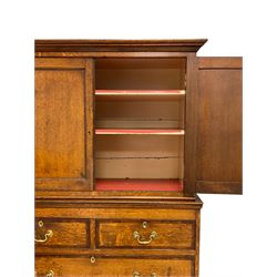 George III oak and mahogany banded cupboard-on-chest, the projecting cornice over two panelled cupboard doors enclosing two shelves, lower section fitted with two short and three long graduating drawers, on bun feet
