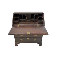 Early George III oak bureau, fall-front with moulded rest and edge, enclosing fitted interior with secret compartment, pigeonholes and cascading shelves, over two short and two long drawers, raised on bracket feet