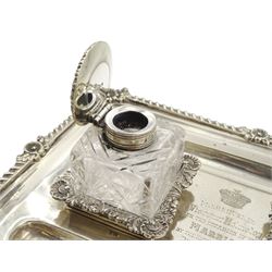 Edwardian silver inkstand of rectangular form with shell moulded and gadrooned edge fitted with two square glass inkwells with hinged silver covers and two pen trays on paw feet. Inscribed 'Presented to Viscount Helmsley on the Occasion of his Marriage.....1904' 23cm x 17cm Provenance: 2nd Earl of Feversham   