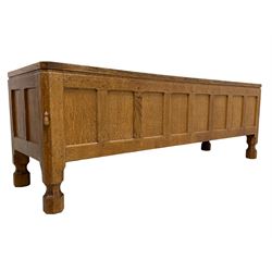 Mouseman - adzed oak blanket chest, hinged top over eight panelled front, carved Mouse signature, on octagonal feet, by the workshop of Robert Thompson, Kilburn 