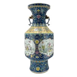 20th century Chinese twin handled floor vase, the cylindrical form body painted with alternating panels of figures and children playing, against a foliate and blue enamel ground, with yellow-banded shoulder and partly gilded mask handles, H92cm 