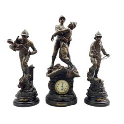 An imposing French spelter clock garniture displaying the patriotic feats of  a team of French firefighters c1910, with an eight-day timepiece movement, white enamel dial with upright Arabic numerals and minute markers, Fleur di lis steel hands, flat bevelled glass within a cast brass bezel and egg and dart slip, movement housed within a stylised flaming building, surmounted by a fireman rescuing a colleague, engraved inscription on a brass plaque to a circular ebonised base 