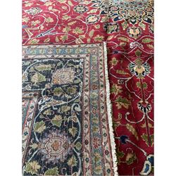 Persian rug with overall floral motifs on a red field and navy border 290cm x 400cm