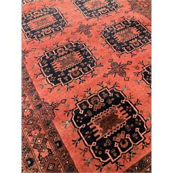 Afghan rug, the red field with geometric motifs, surrounded by borders with floral motifs 