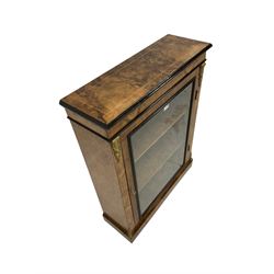 Late 19th century figured walnut pier display cabinet, rectangular top with satinwood stringing, fitted with single glazed door enclosing  two shelves, uprights with gilt metal mounts decorated with flower heads and scrolling, on plinth base