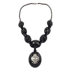 Victorian Whitby jet mourning necklace, oval faceted jet locket with applied silver monogram, suspending from jet oval panels, on silver rope twist chain hallmarked