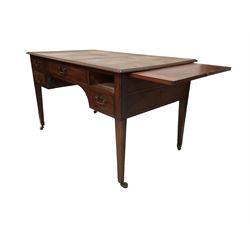 George III mahogany library table or desk, rectangular top with moulded edge, extending brushing slides to each side, fitted with central frieze drawer flanked by two small drawers, faux drawers to the reverse and sides with ebony stringing and key holes, raised on square tapering supports terminating in brass cups and castors