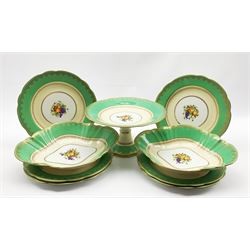 Aynsley dessert service painted with a centre panel of fruit within a green and gilt border comprising six plates, two oval dishes and a comport
