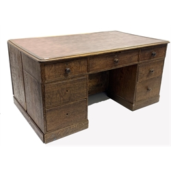 19th century oak estate twin pedestal desk, skivered top over one long drawer and two banks of three short graduating drawers, opposite panelled cupboards enclosing two banks of four slides, on skirted base, 164cm x 100cm, H80cm
